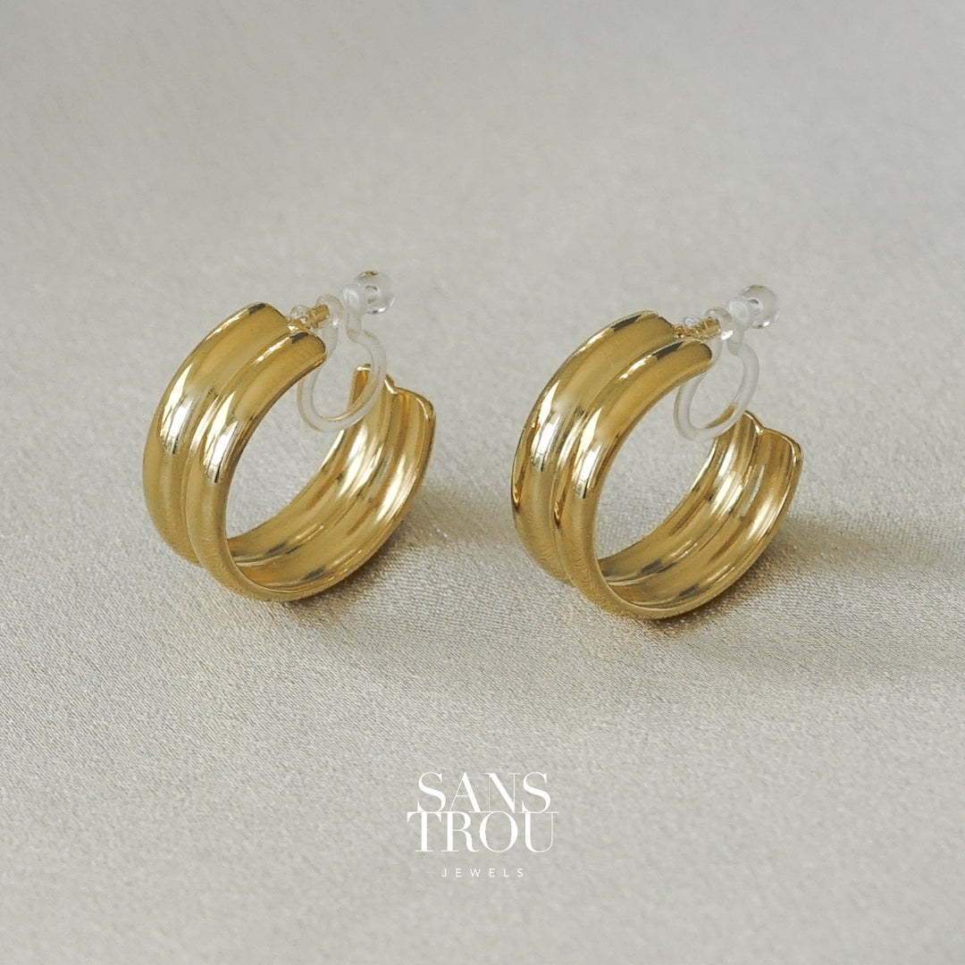 Sans Trou 18k gold plated clip-on earring with a double banded thick hoop style. 