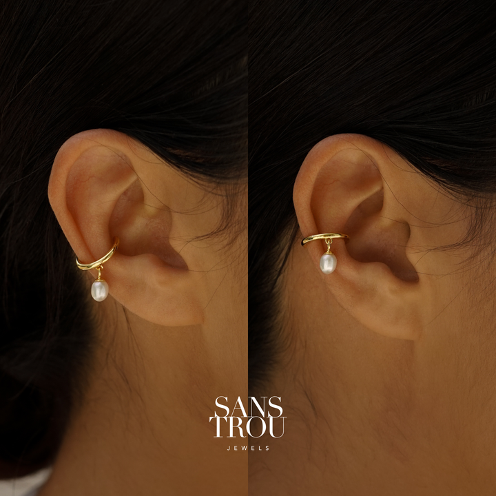 Close up of an ear cuff with dainty dangle freshwater pearl worn on an ear. Branded SANS TROU