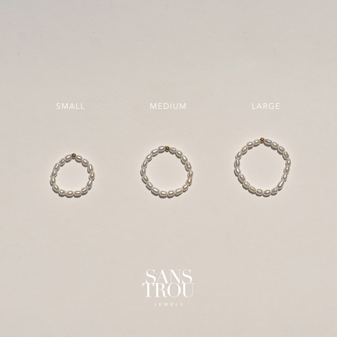 Three pearl rings of different sizes labeled 'Small', 'Medium', and 'Large' on a beige background with 'Sans Trou Jewels' branding.