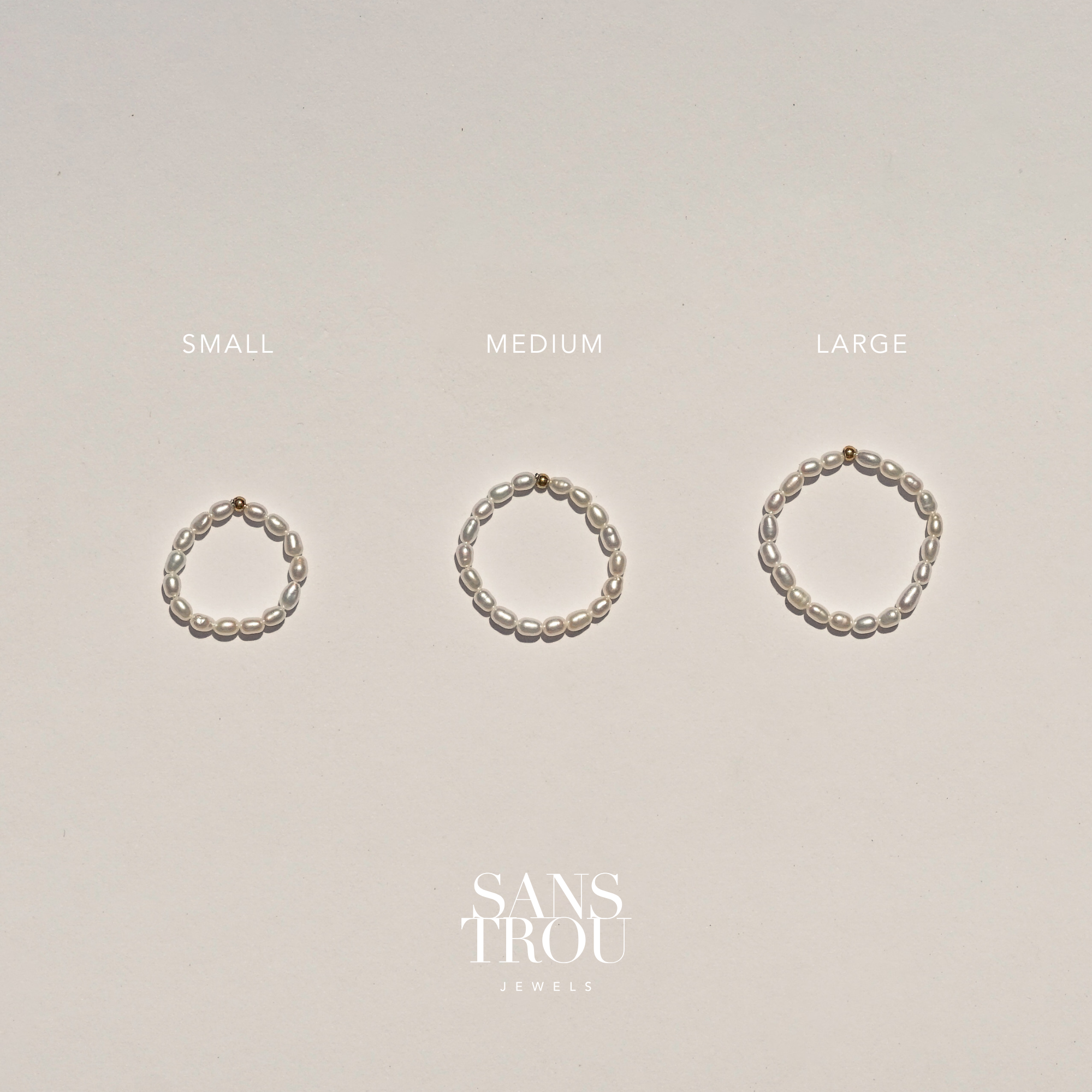 Three pearl rings of different sizes labeled 'Small', 'Medium', and 'Large' on a beige background with 'Sans Trou Jewels' branding.