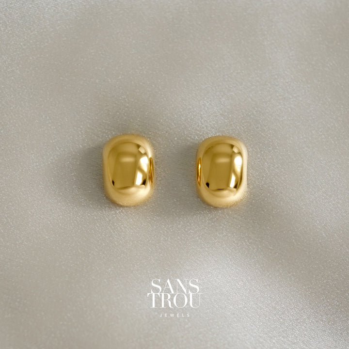 Pair of gold dome/ bean shaped clip-on earrings with reflective mirrored surface