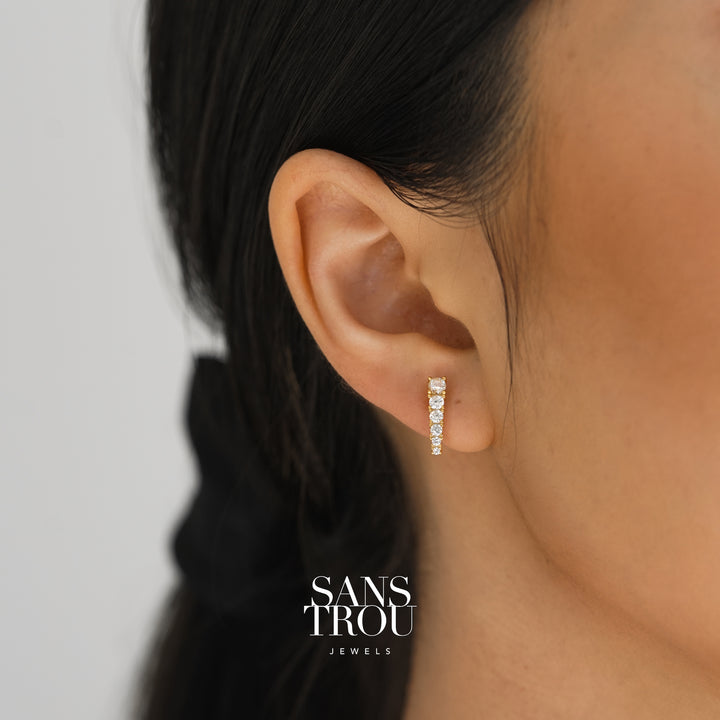 Model wearing 18k gold plated studs with CZ stones. 