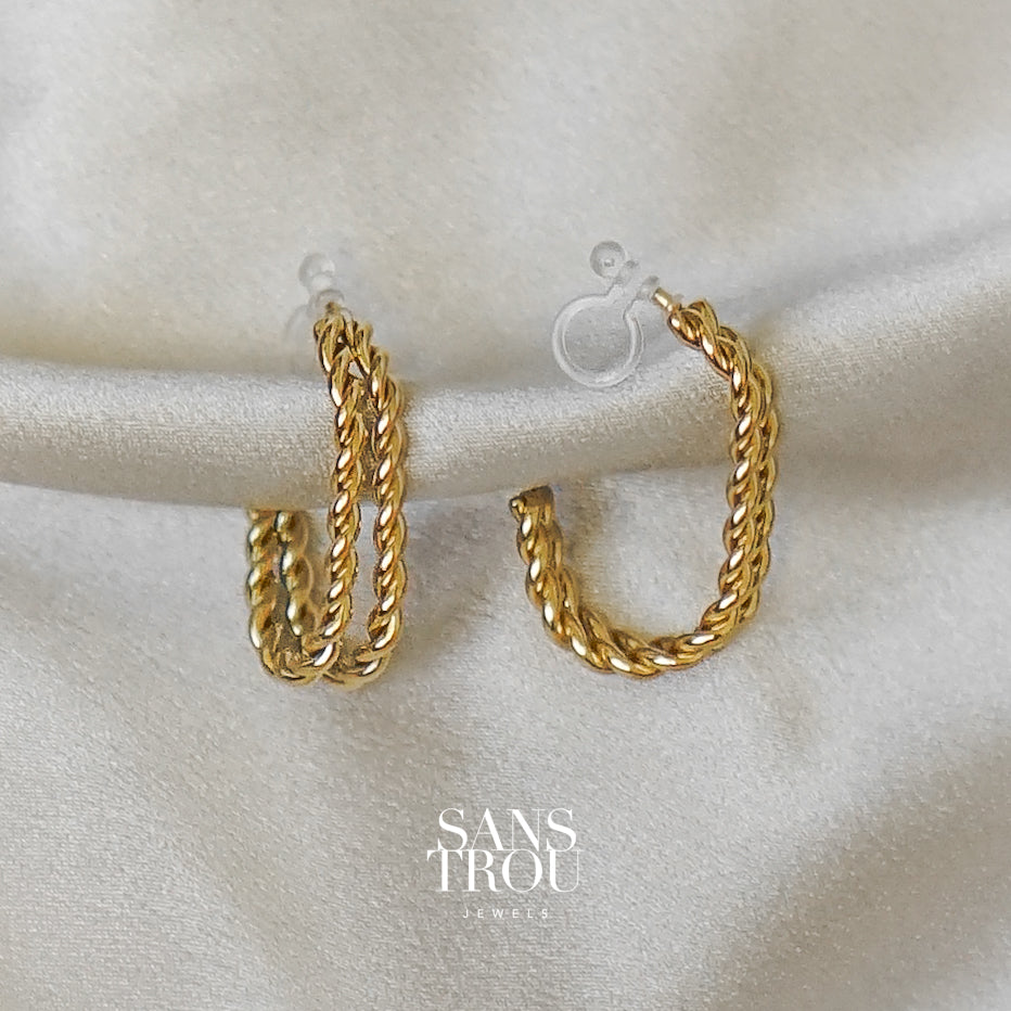 Sans Trou gold clip-on earrings made with two twisted rope bars that come together in a half hoop shape