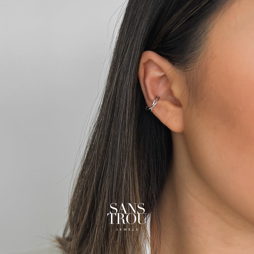 Model wears a sterling silver criss cross style ear cuff as a conch piercing.