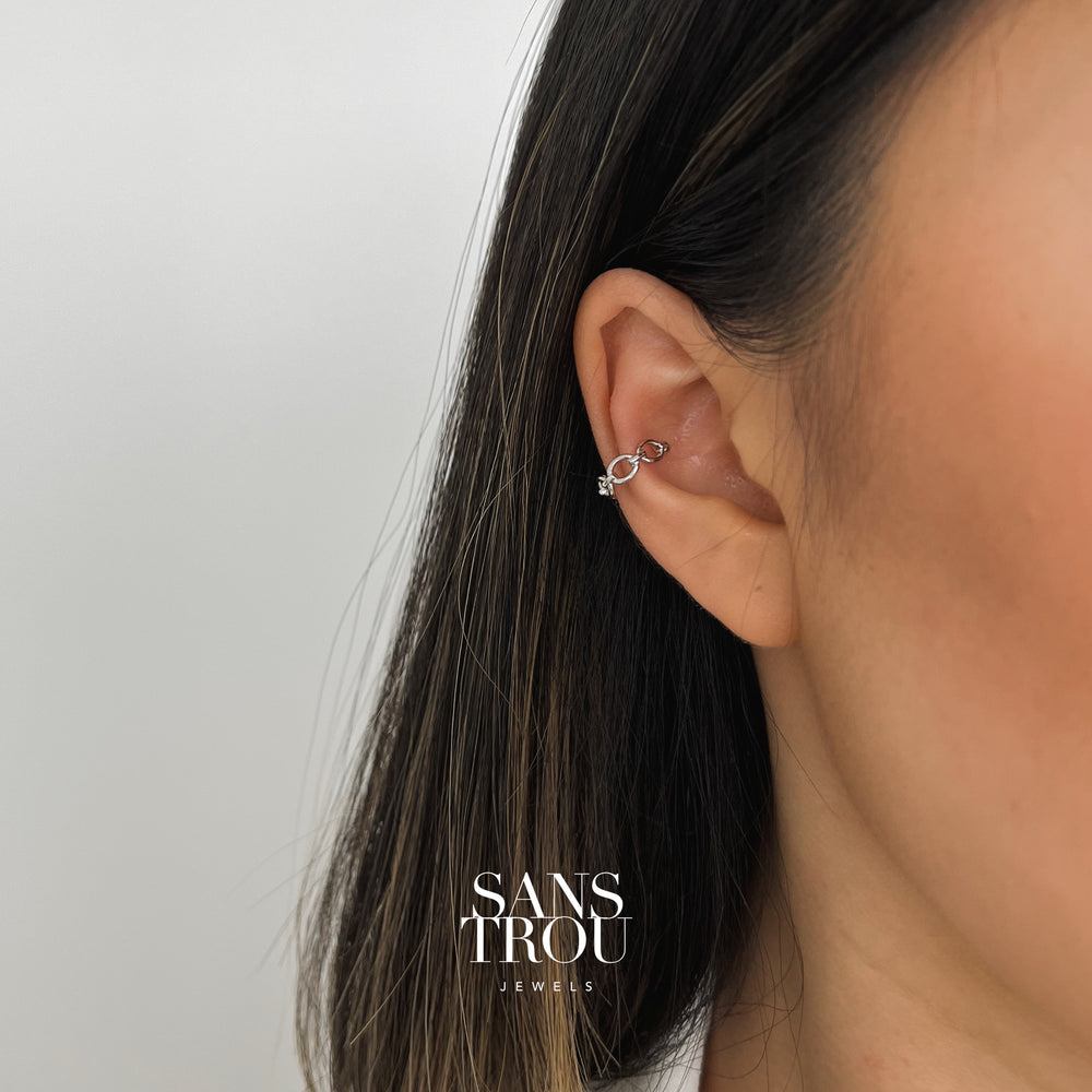 Model wears sterling silver ear cuff with a dainty rounded chain style on the cartilage.