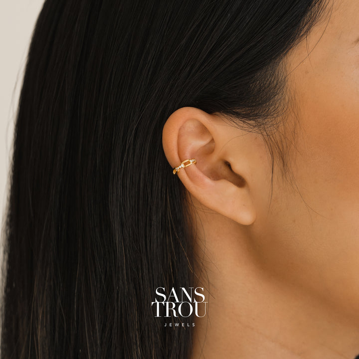 Model wears dainty chain ear cuff with 18k gold plating and CZ stones on the cartilage. 