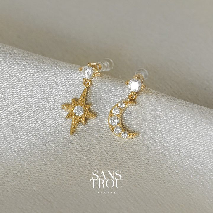 Sans Trou star and moon duo clip-on earrings. This dainty duo features 18k gold plating and CZ stones. No piercings need. 
