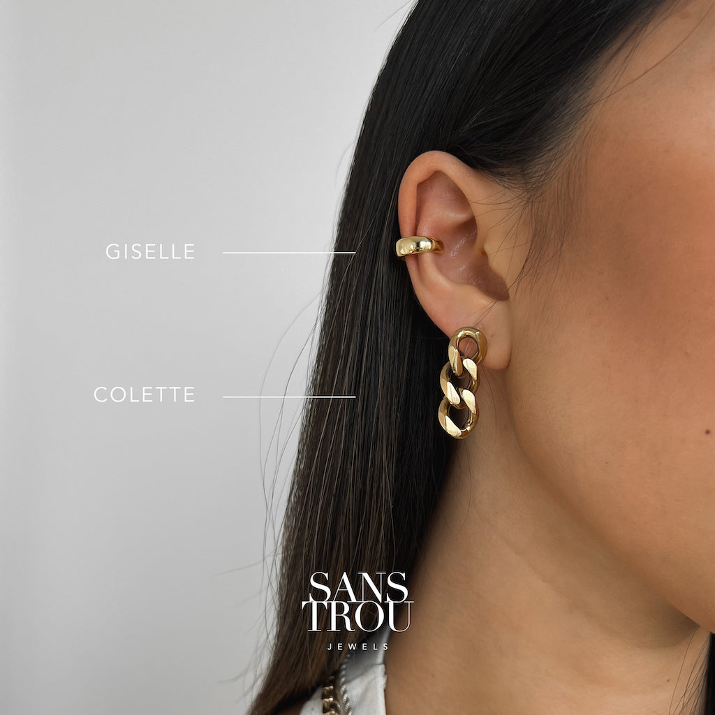 Model wears a chunky and minimal ear cuff with 18k gold plating on the cartilage.