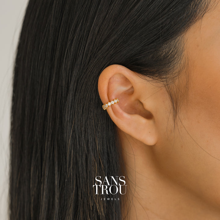 Model wears a 18k gold plated ear cuff with studded CZ stones on the helix. 