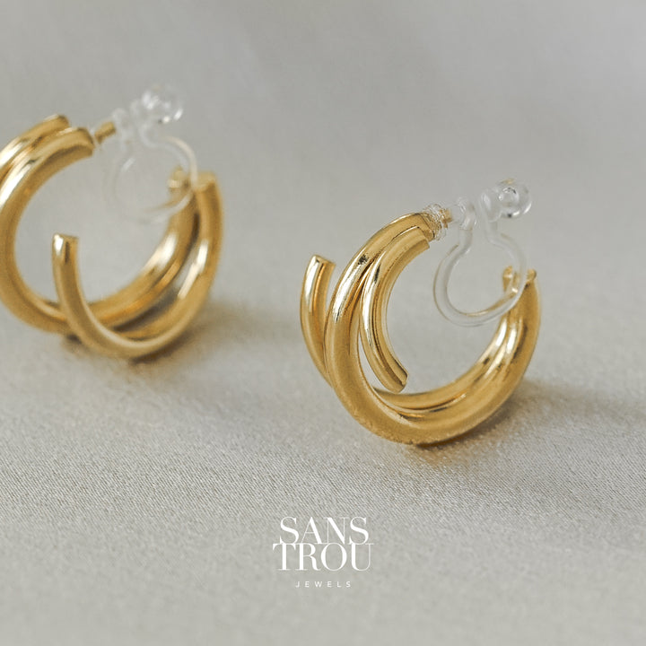 Sans Trou 18k gold plated spiral clip-on earring. The Liana has an asymmetrical pair and is worn on the lobe. 