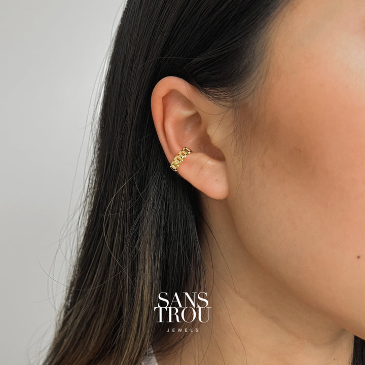 Model wears 18k gold plated chain ear cuff on the conch. 